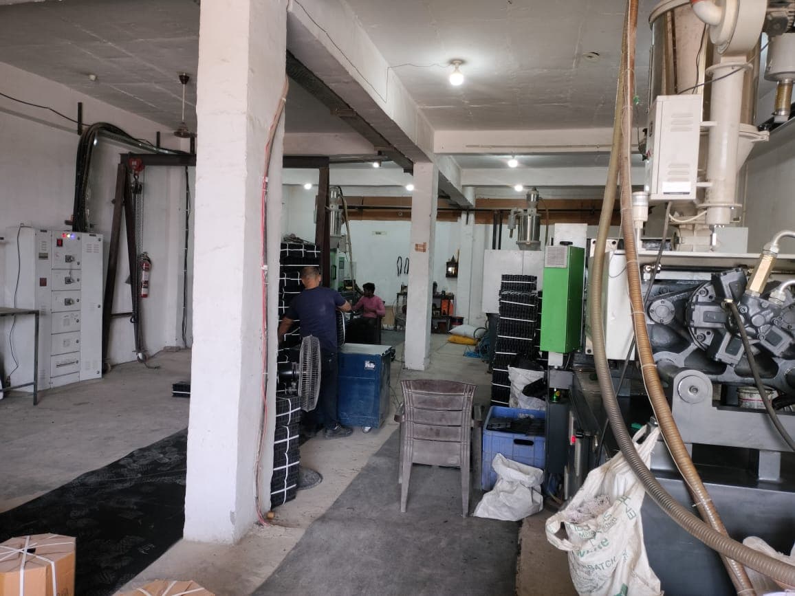 Workers operating injection moulding machines at Anil Industry